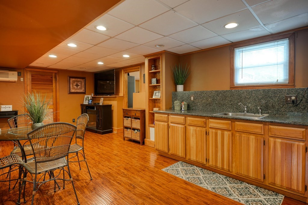 14 Princeton Road Burlington, MA 01803 - Photo 25 of 40 a open kitchen with stainless steel appliances granite countertop a refrigerator a sink dishwasher a dining table and chairs with wooden floor
