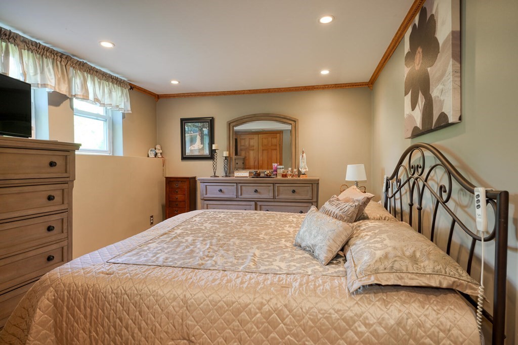 14 Princeton Road Burlington, MA 01803 - Photo 27 of 40 a bedroom with a large bed and a flat tv screen on dresser