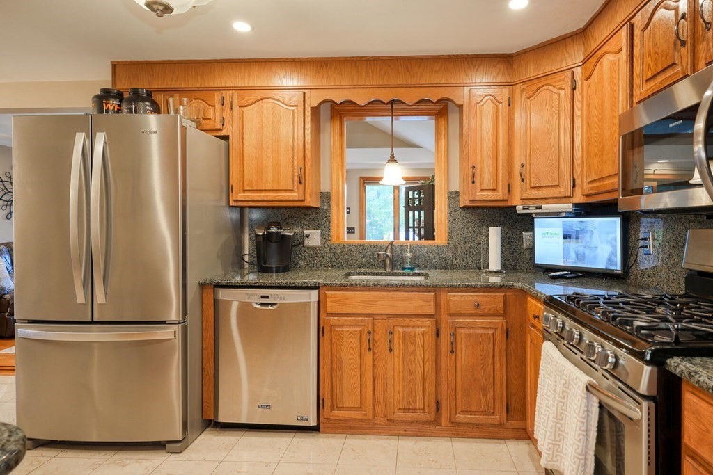14 Princeton Road Burlington, MA 01803 - Photo 8 of 40 a kitchen with stainless steel appliances granite countertop a refrigerator a stove and a sink