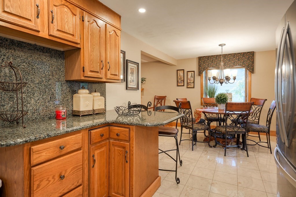 14 Princeton Road Burlington, MA 01803 - Photo 9 of 40 a kitchen with stainless steel appliances granite countertop a sink dishwasher and cabinets with wooden floor