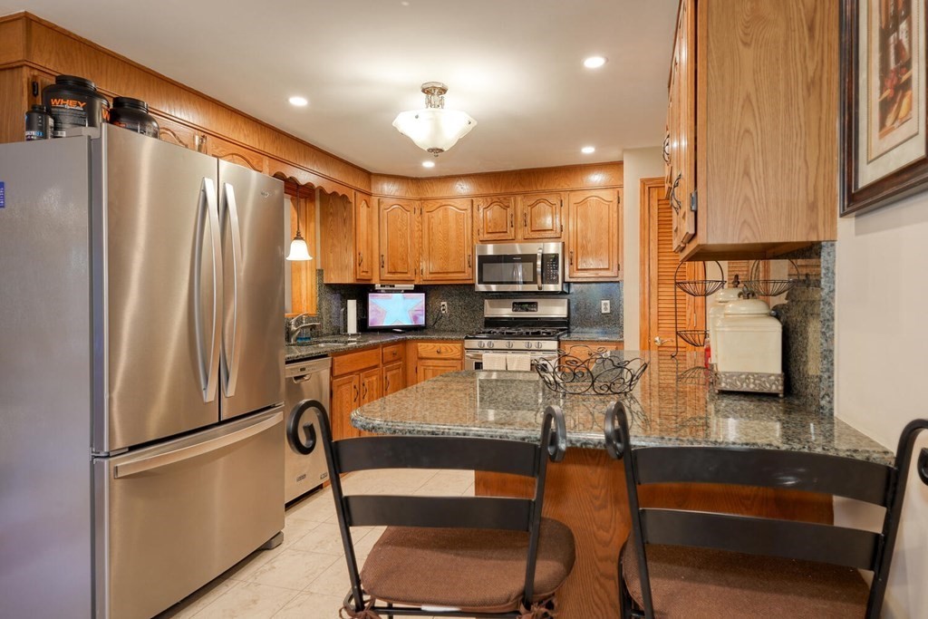 14 Princeton Road Burlington, MA 01803 - Photo 10 of 40 a kitchen with stainless steel appliances a refrigerator and a stove top oven
