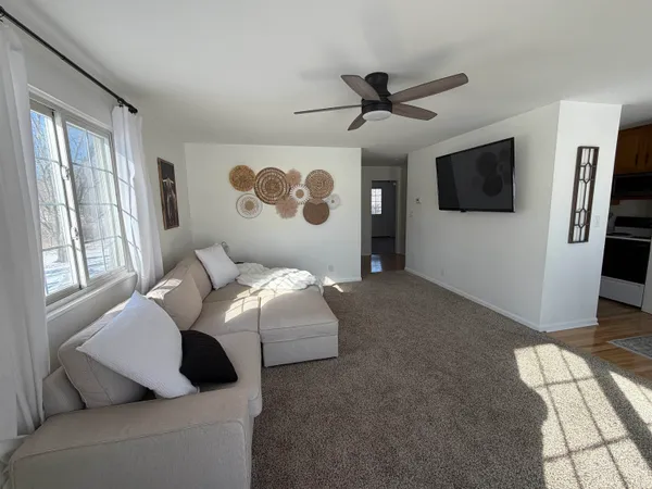 a view of a dining room with furniture window and wooden floor