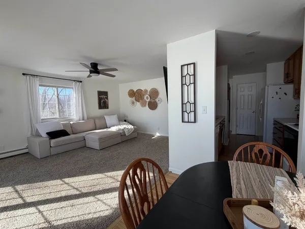 a bedroom with a bed and a flat tv screen on dresser