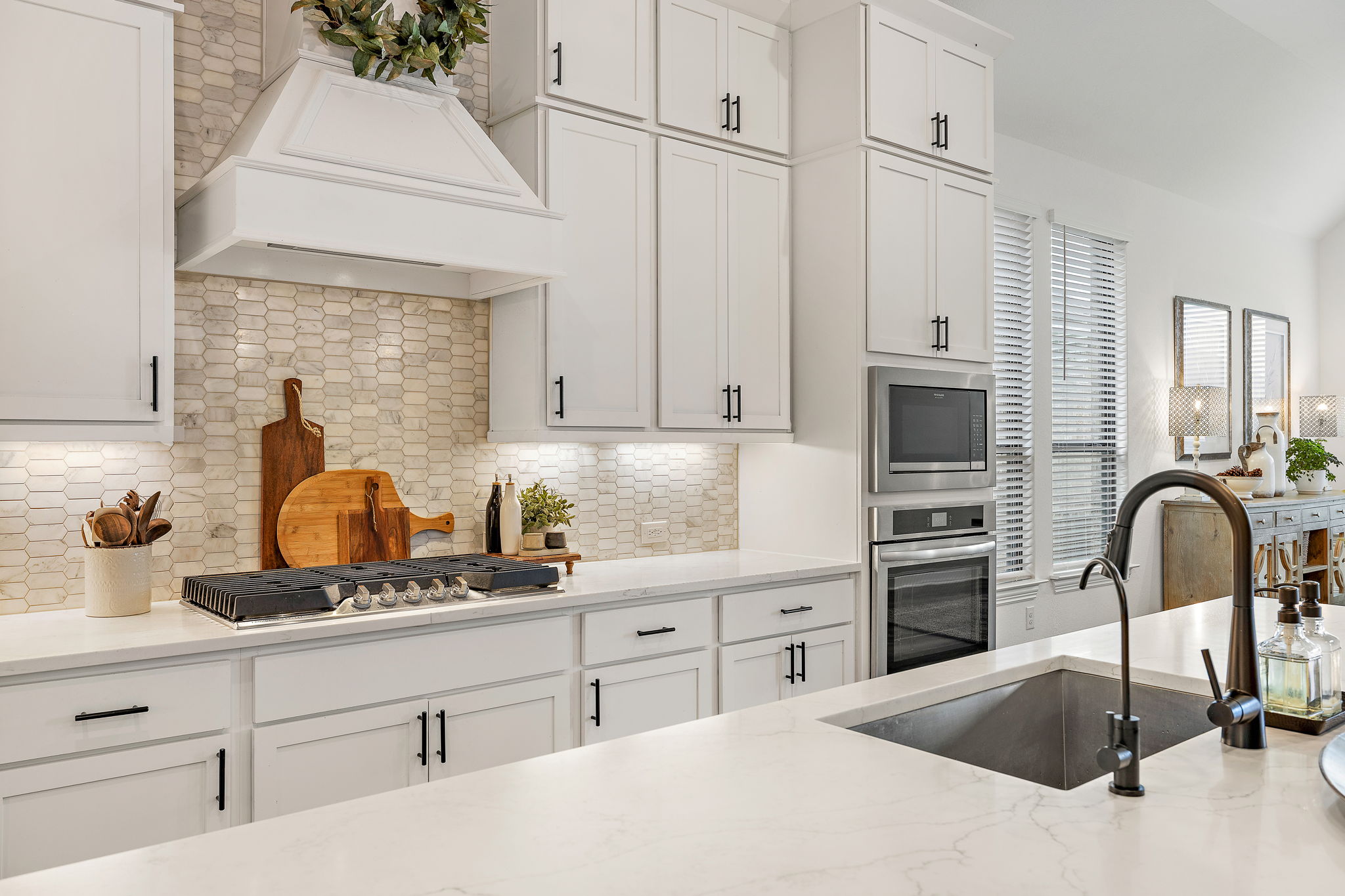 181 Constitution Way Kyle, TX 78640 - Photo 13 of 32 a kitchen with white cabinets and sink