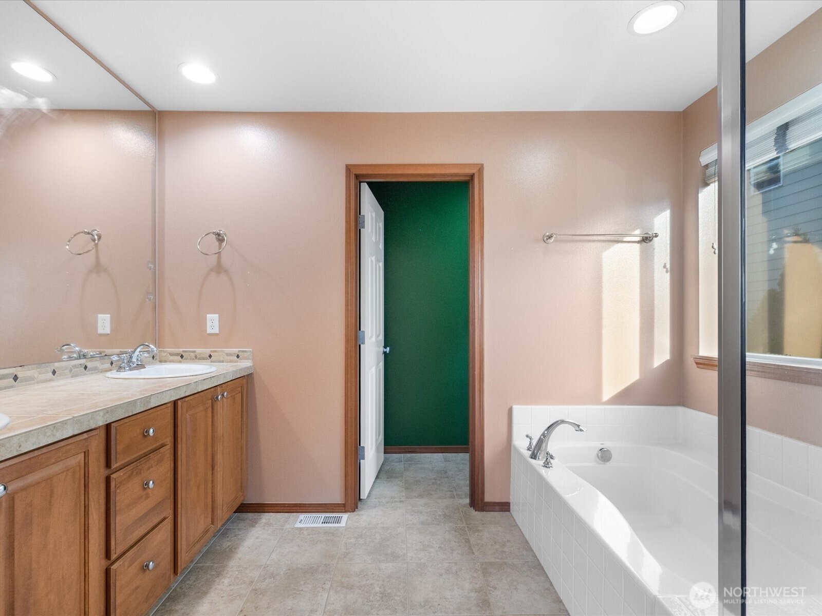 1824 23rd Street Snohomish, WA 98290 - Photo 29 of 38 a bathroom with a tub a sink and mirrors