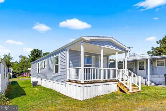 a view of a house with a backyard and a patio
