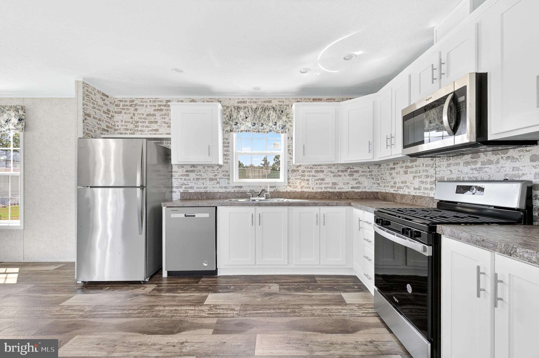 105 Bordic Road Reading, PA 19606 - Photo 14 of 26 a kitchen with stainless steel appliances granite countertop a stove a refrigerator and a microwave