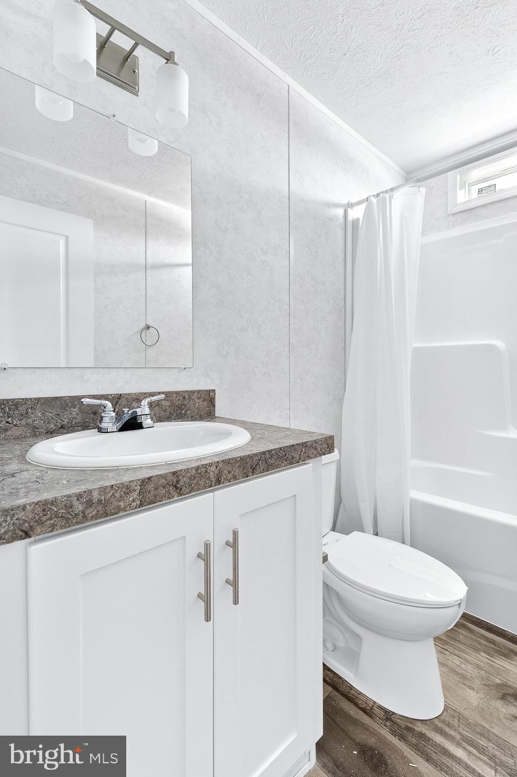 105 Bordic Road Reading, PA 19606 - Photo 7 of 26 a bathroom with a granite countertop sink a toilet a mirror and shower