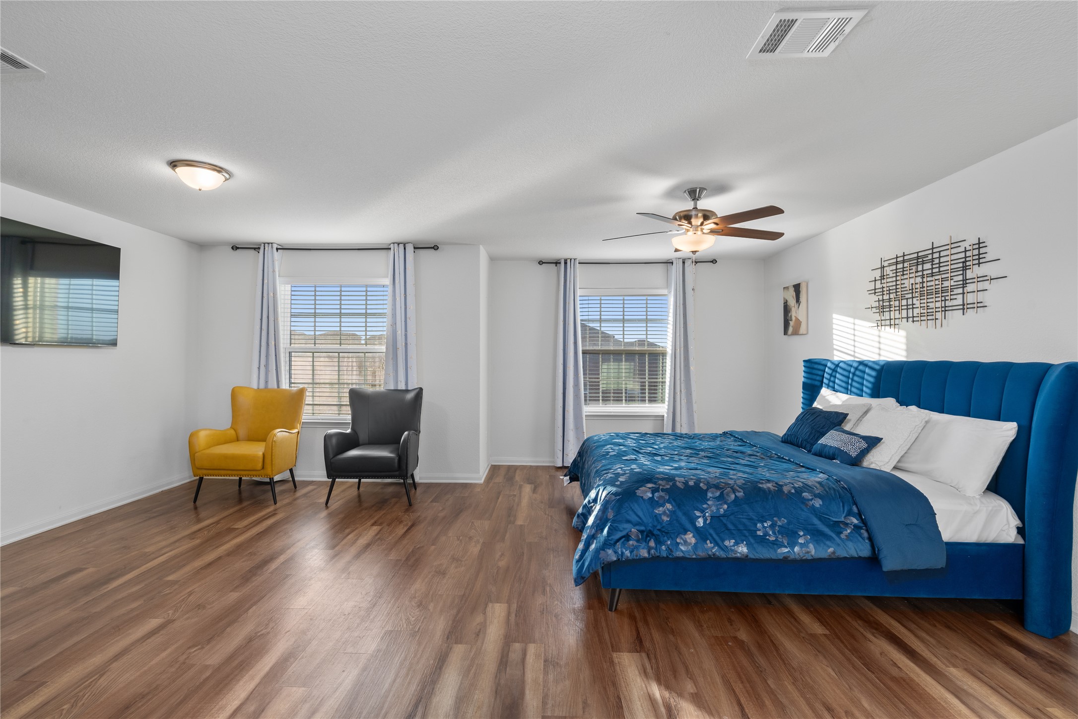 20205 Grover Cleveland Way Manor, TX 78653 - Photo 17 of 26 a bedroom with a bed and wooden floor