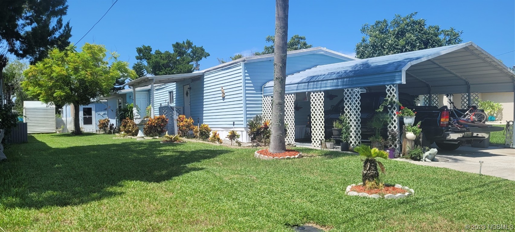 153 Douglas Street Edgewater, FL 32141 - Photo 1 of 2 a front view of a house with a yard table and chairs
