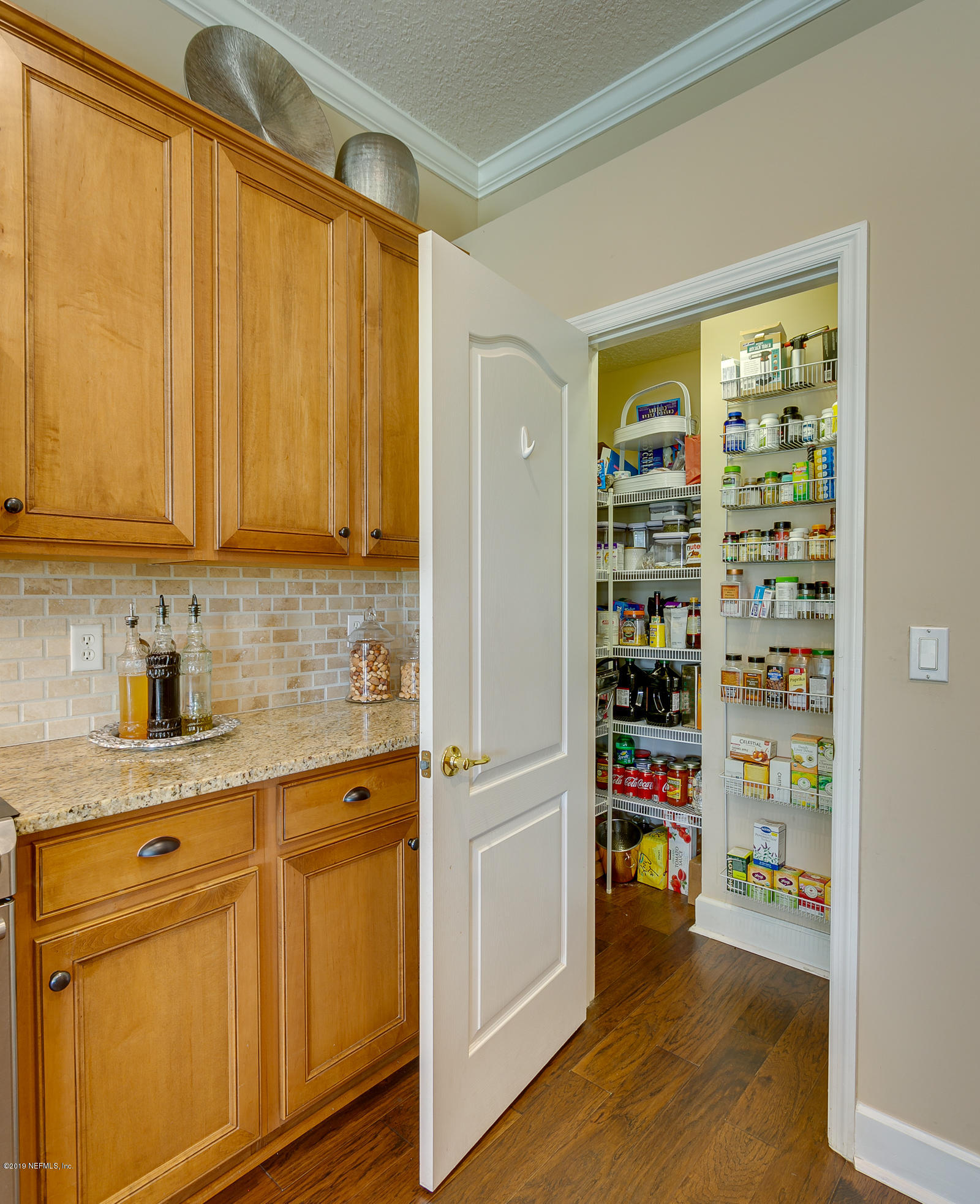 1312 Powis Road St. Augustine, FL 32095 - Photo 13 of 43 a kitchen with stainless steel appliances a refrigerator and cabinets