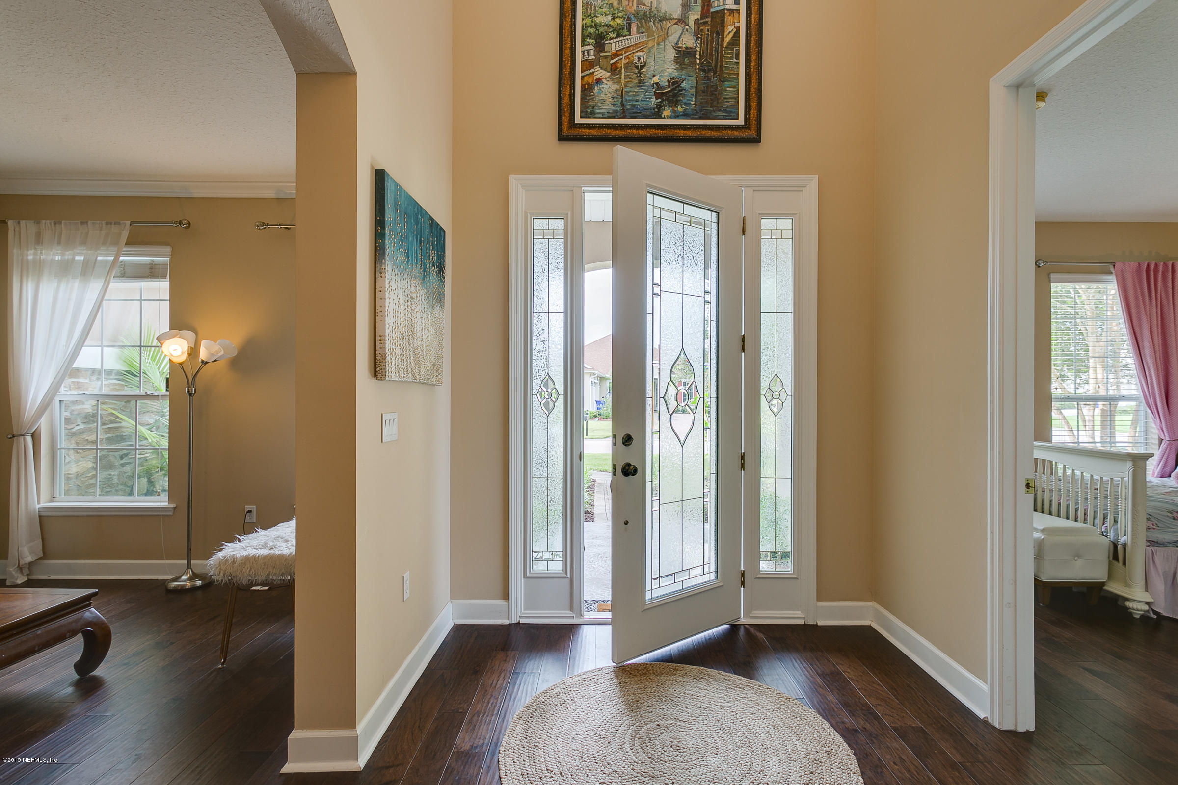 1312 Powis Road St. Augustine, FL 32095 - Photo 3 of 43 a view of a hallway with wooden floor and a bedroom