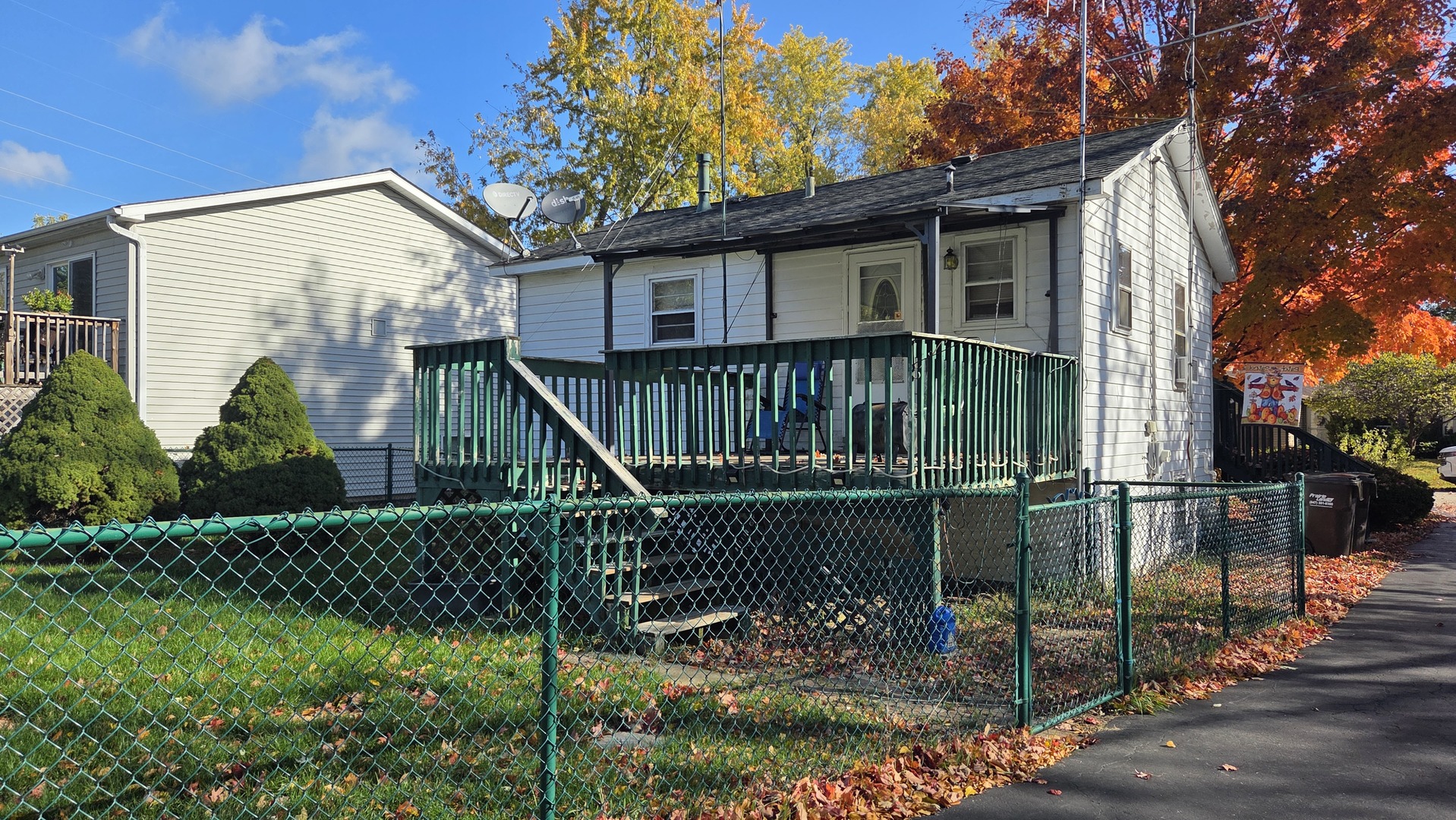 5313 Burwood Road Oakwood Hills, IL 60013 - Photo 4 of 28 a view of a house with a small yard and a wooden deck