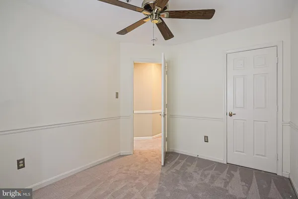 a view of a room with closet and a ceiling fan