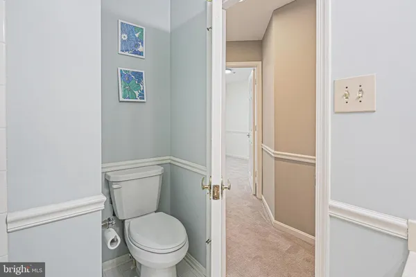 a white toilet sitting next to a bathroom sink