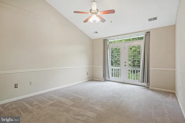 a view of a livingroom with an empty space and a ceiling fan