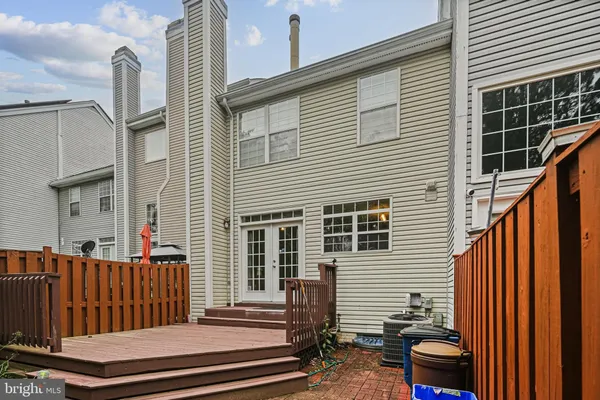 a view of a house with wooden fence