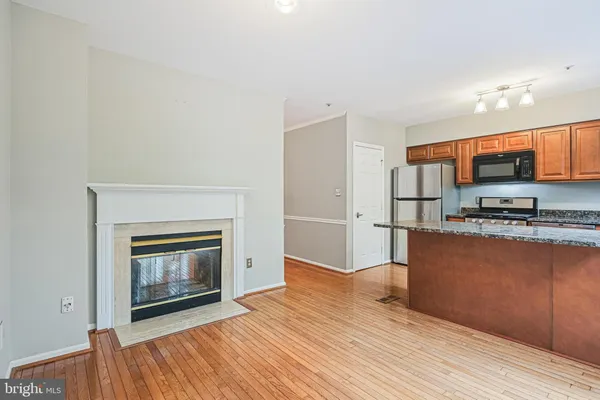 a kitchen with stainless steel appliances a stove top oven and a refrigerator