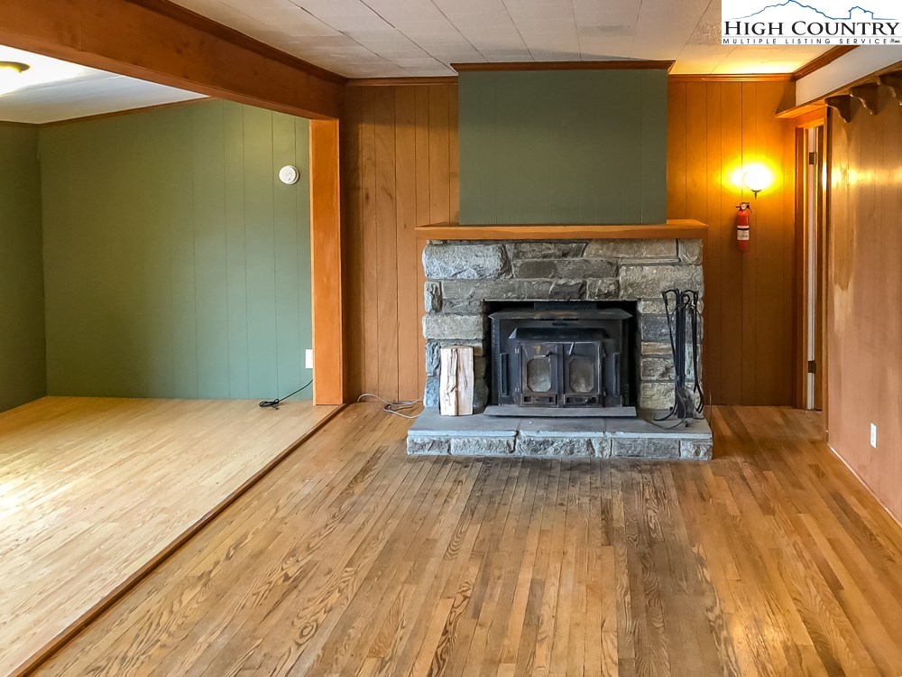 277 Rabbit Run Road, Unit A&B Boone, NC 28607 - Photo 17 of 19 a view of empty room with wooden floor and fireplace