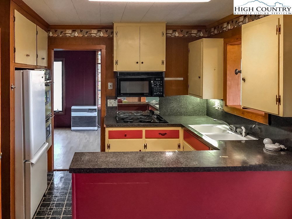 277 Rabbit Run Road, Unit A&B Boone, NC 28607 - Photo 18 of 19 a kitchen with granite countertop a sink and a refrigerator