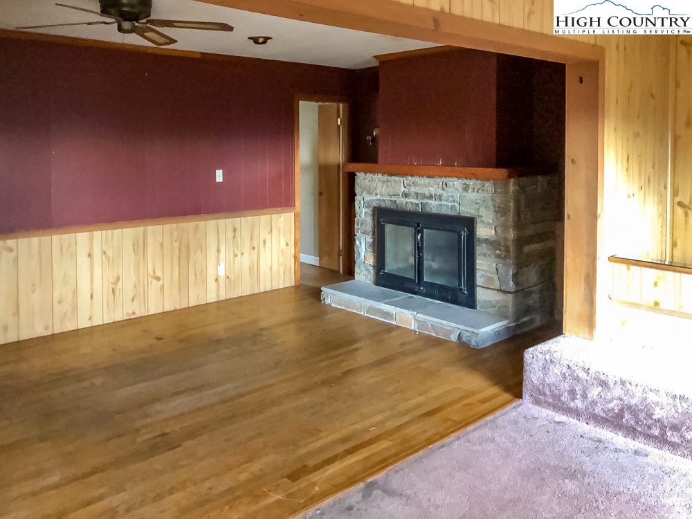 277 Rabbit Run Road, Unit A&B Boone, NC 28607 - Photo 8 of 19 a view of an empty room with a fireplace and a window
