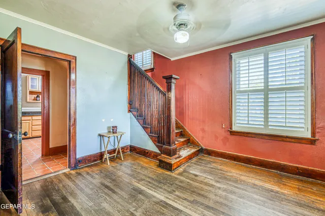 a view of a kitchen with stainless steel appliances granite countertop white cabinets and window
