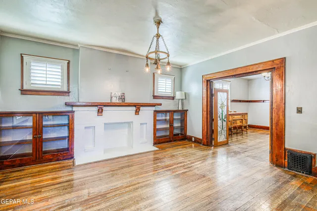 a kitchen with stainless steel appliances granite countertop a refrigerator a oven and white cabinets
