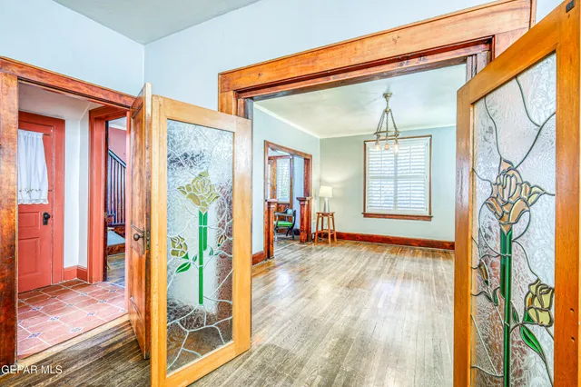 a view of a hallway with wooden floor and entryway