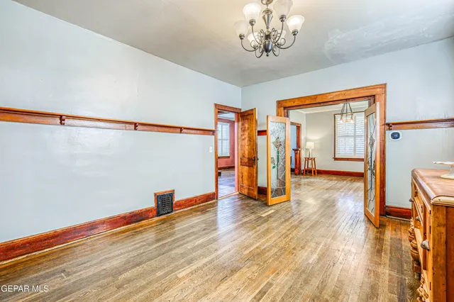 a view of a hallway with wooden floor and closet