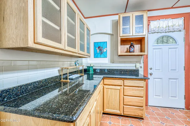 a view of a porch with a door and wooden floor
