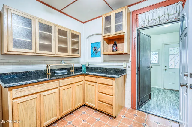 a view of porch with a floor to ceiling window and wooden fence