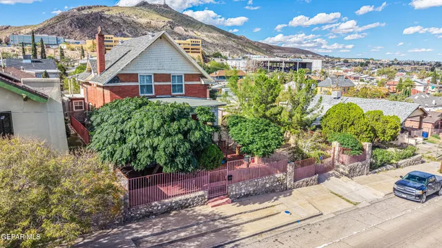 a view of a room with wooden floor and a ceiling fan