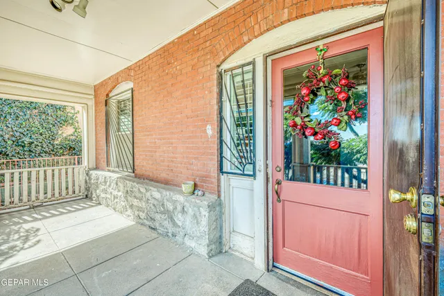 a view of a livingroom with wooden floor and a chandelier