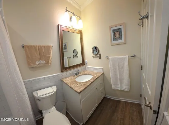 a bathroom with a granite countertop toilet sink and mirror