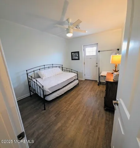 a spacious bedroom with a bed and a chandelier