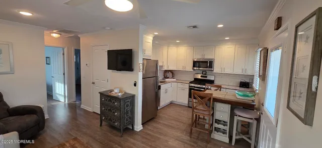a kitchen with stainless steel appliances granite countertop a refrigerator stove and sink