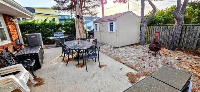a view of a patio with a table and chairs