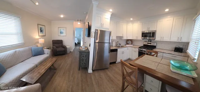 a kitchen with a refrigerator and a stove top oven