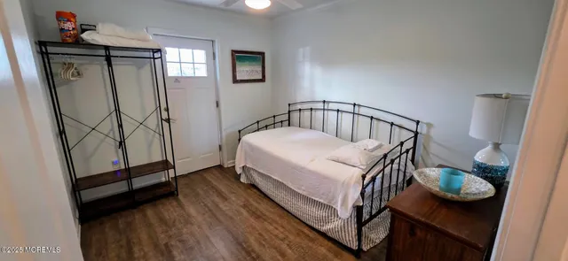 a bedroom with a bed and a mirror