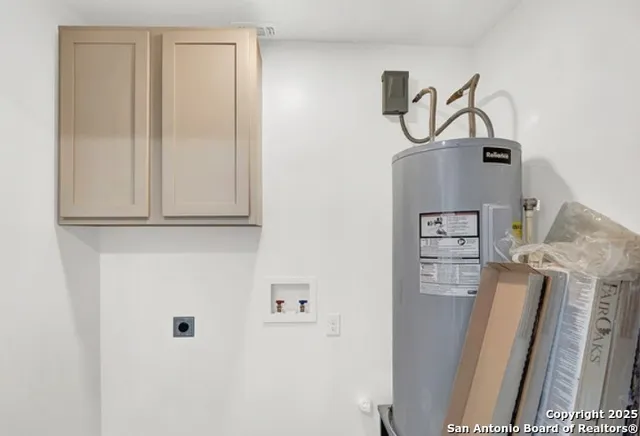 a view of cabinet with washer and dryer