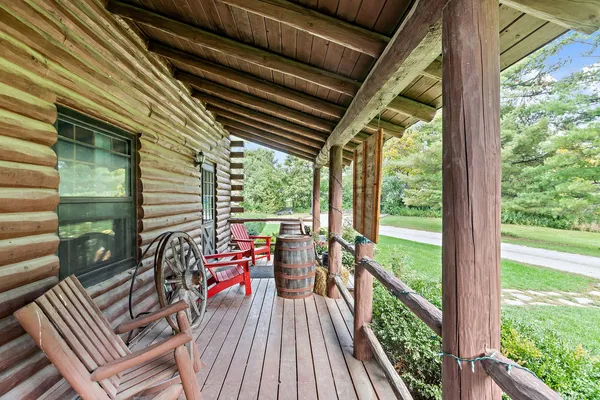 a view of deck with furniture and garden