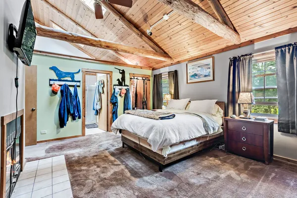 a spacious bedroom with a bed and a large window