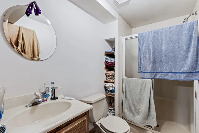 a bathroom with a sink mirror and toilet