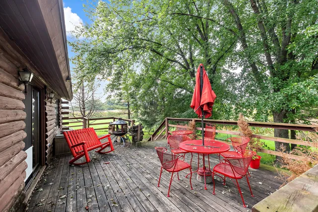 an outdoor sitting area with furniture and wooden floor