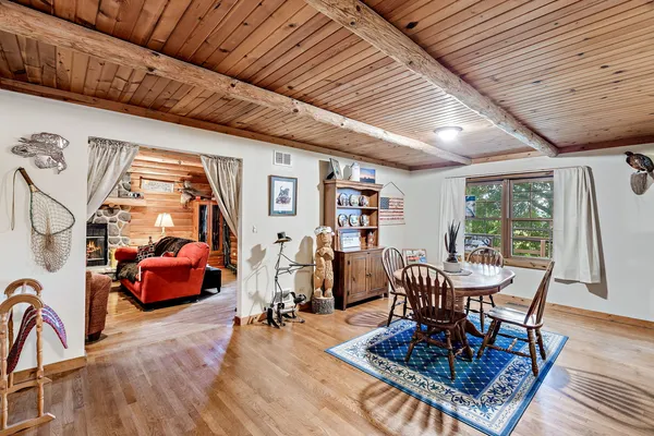 a dining room with furniture and wooden floor