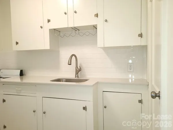 a kitchen with stainless steel appliances white cabinets and a sink
