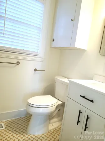 a bathroom with a toilet and a sink