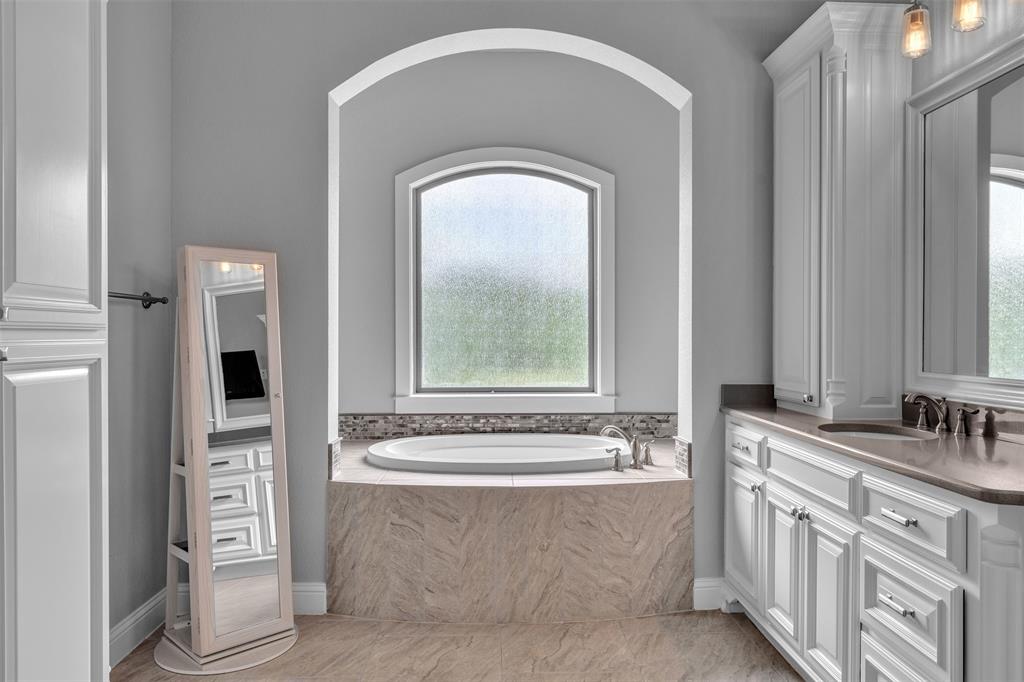 1060 Waters Edge Court Oak Point, TX 75068 - Photo 28 of 40 a bathroom with a bathtub and a sink