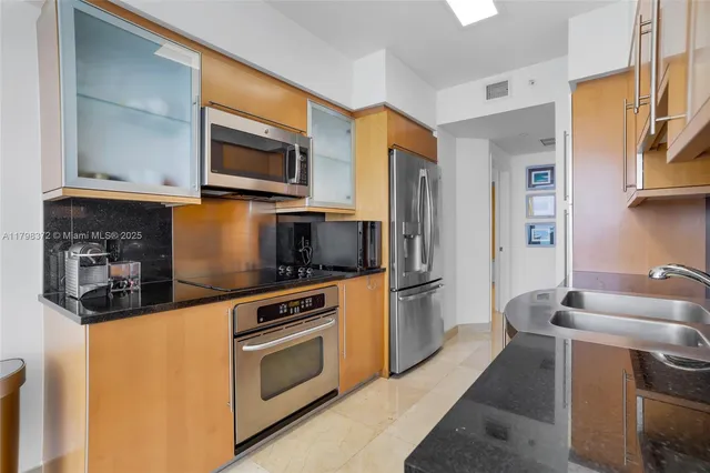 a kitchen with stainless steel appliances a stove microwave and a sink