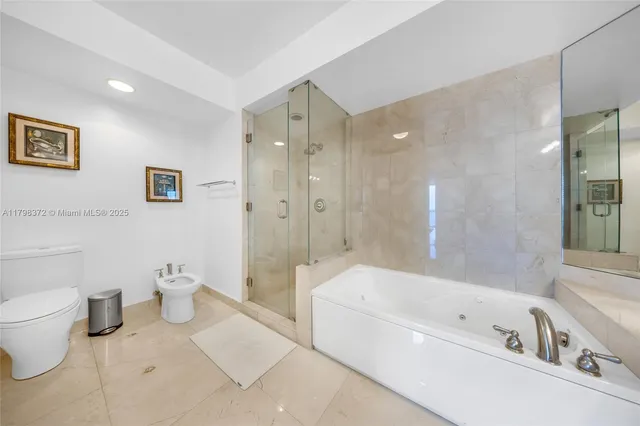 a bathroom with a bathtub a toilet a sink and shower